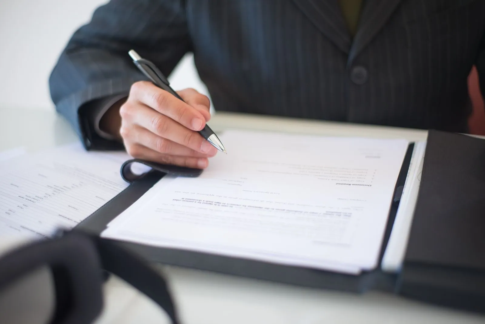 Contract being signed at a desk