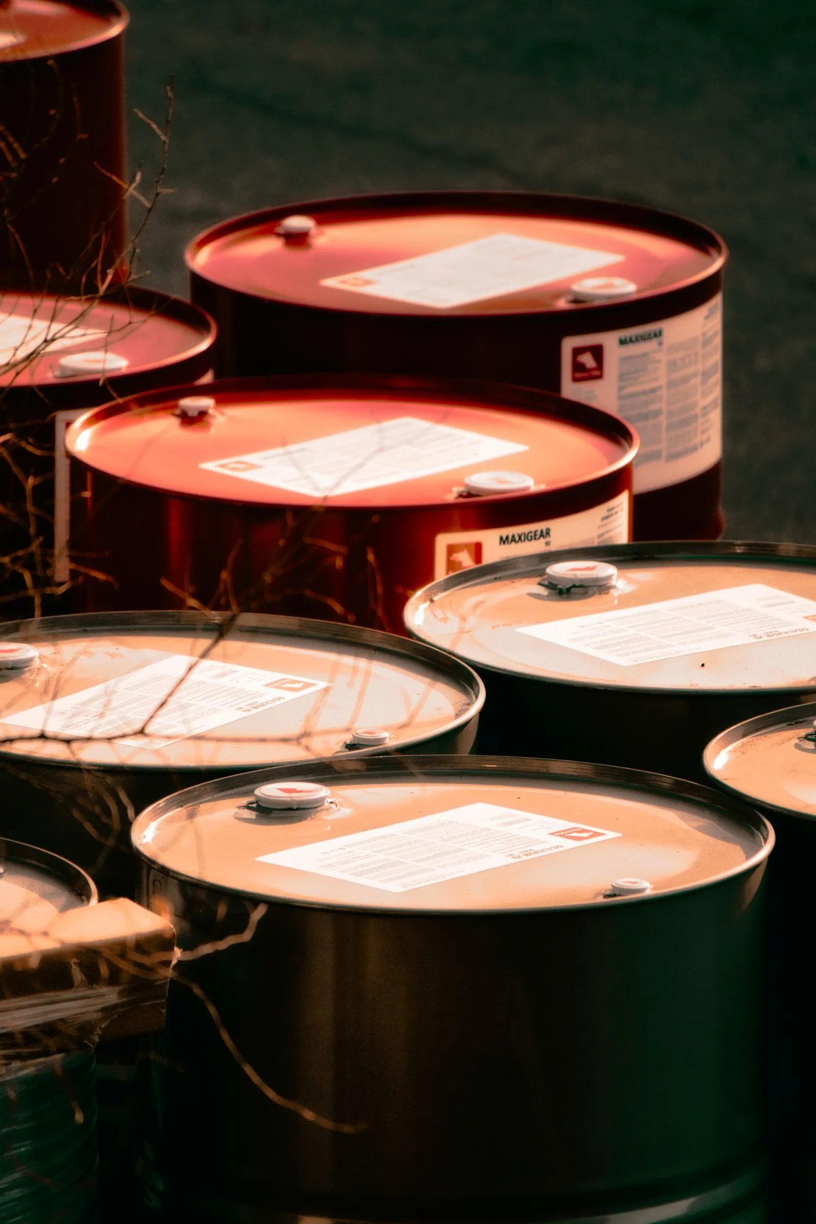Open steel drums under warm workshop lighting