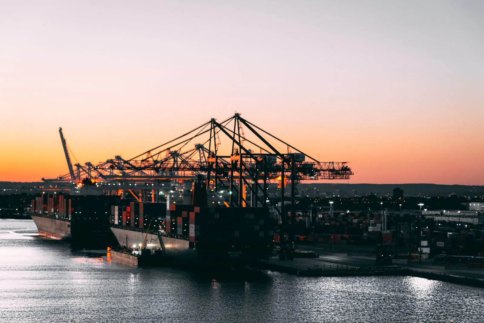 Industrial harbour at dusk with berthed vessels