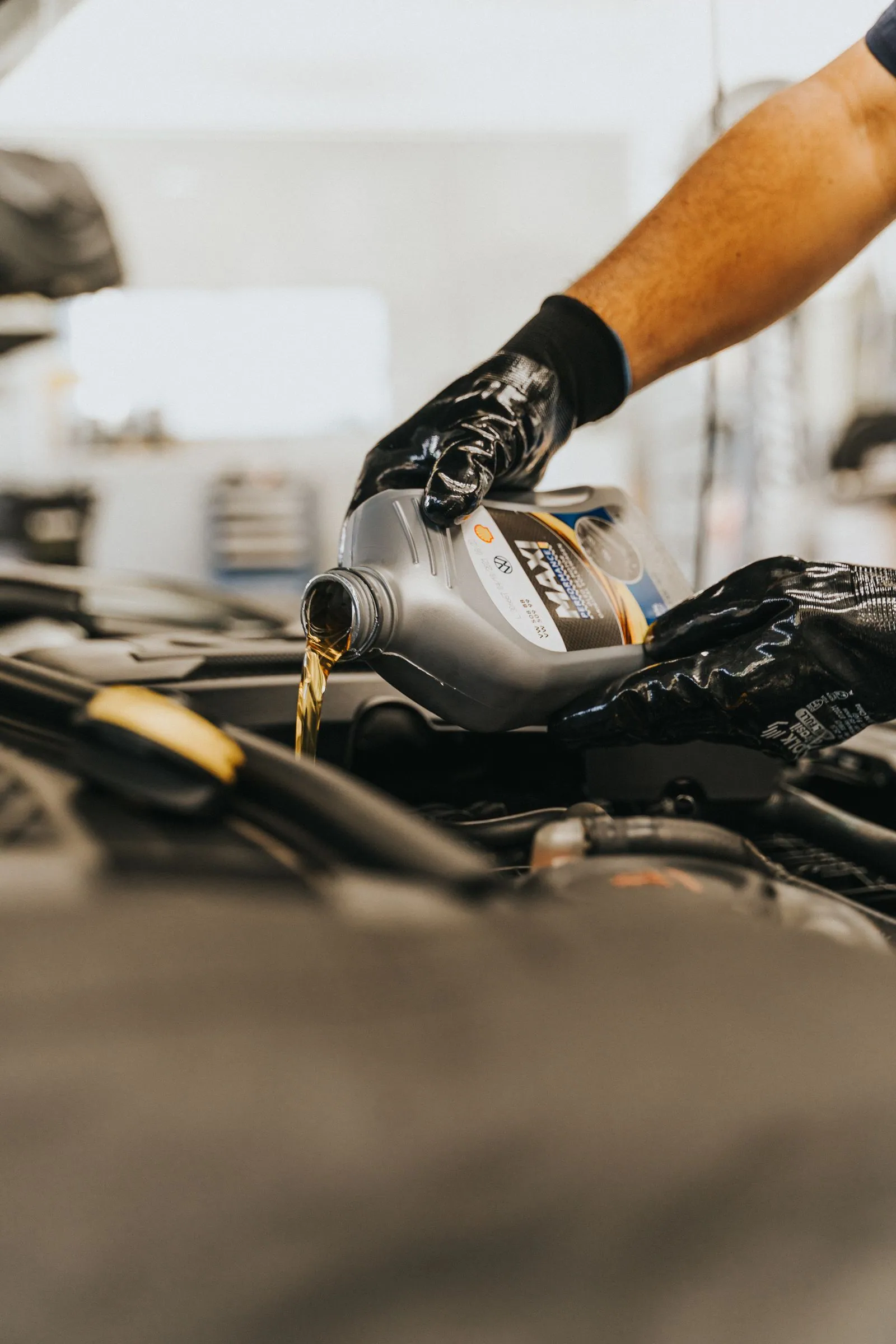 Golden lubricating oil being poured during a service