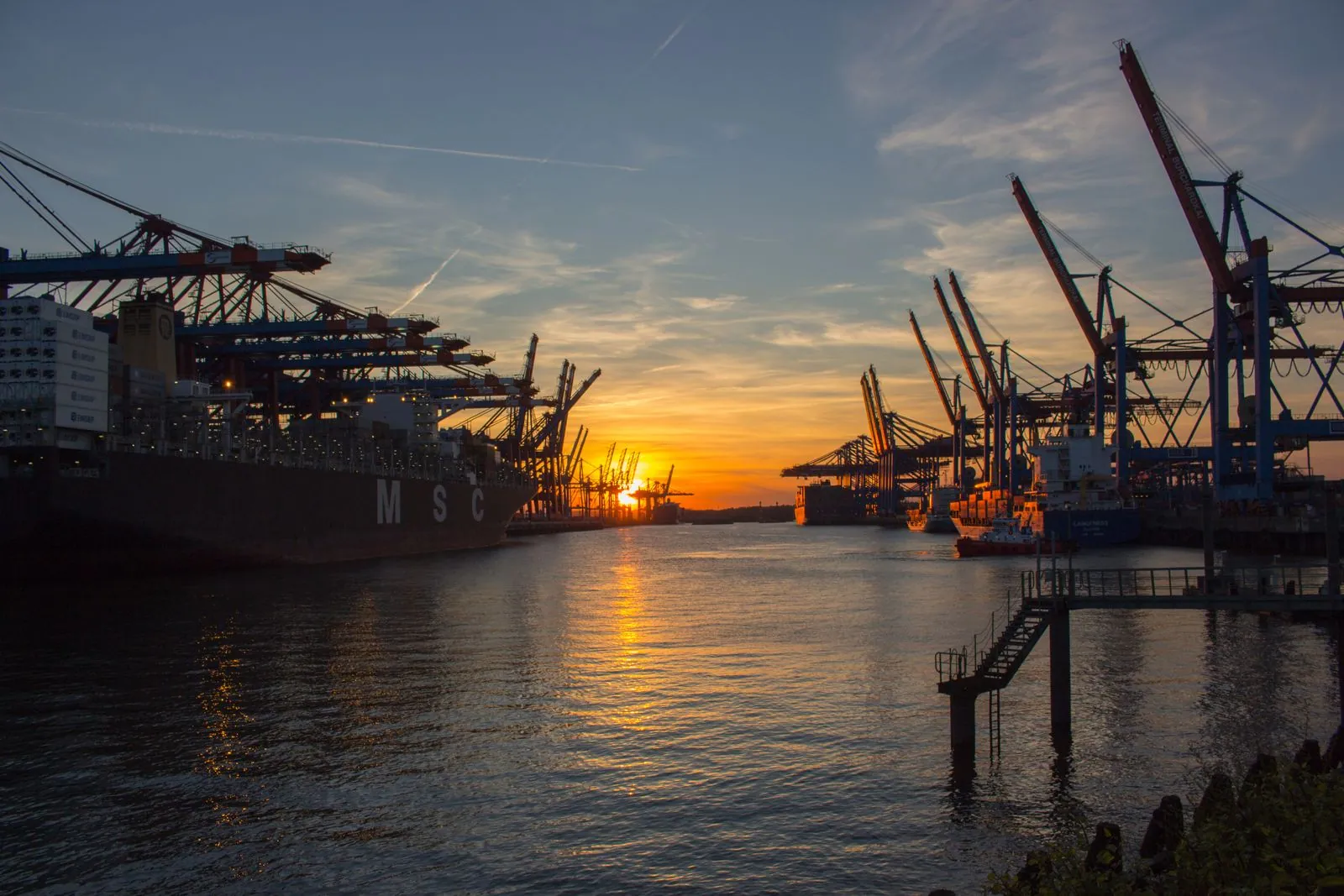 Port cranes silhouetted at dusk