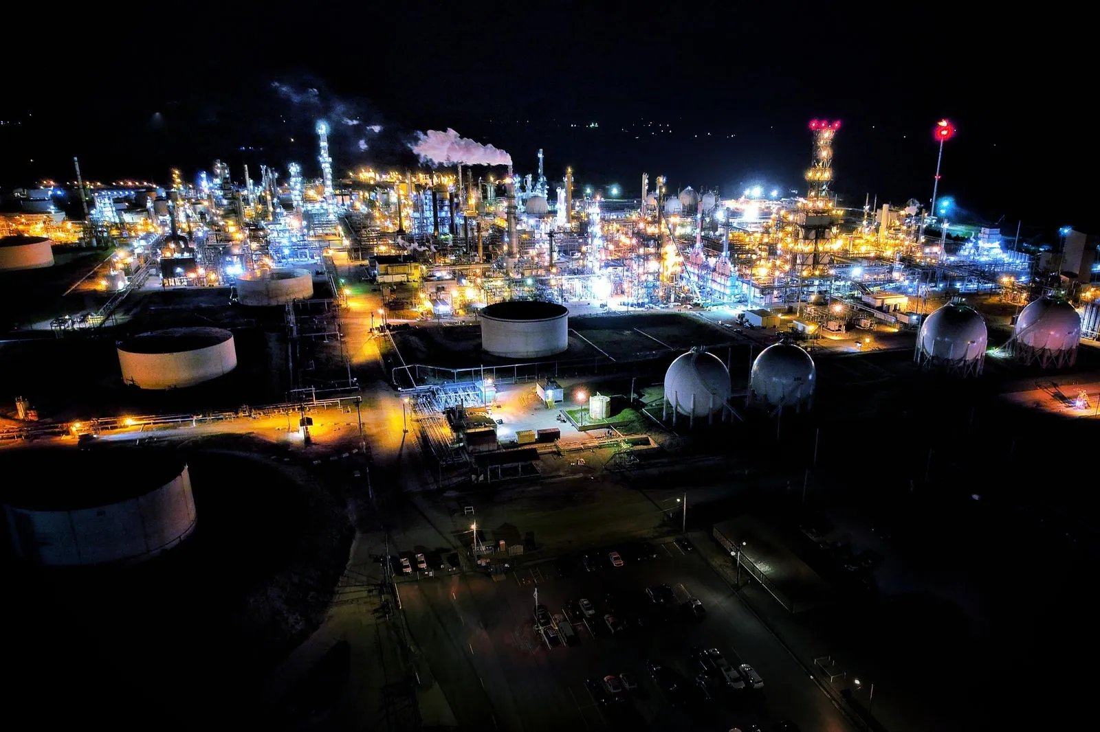 Aerial view of a refinery complex illuminated at night